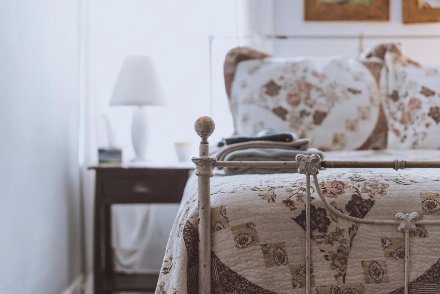Quiet hotel guest room with a made bed and bedside lamp ready for arrival